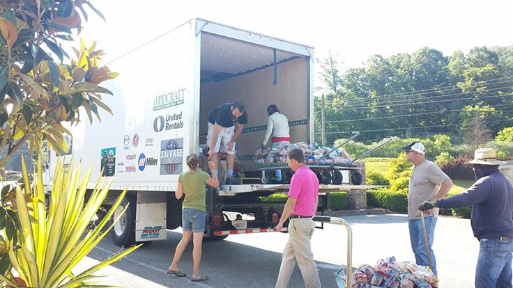 People unloading a truck