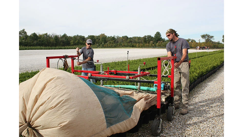 Workers at Decker's Nursery in Groveport, Ohio trim plants.