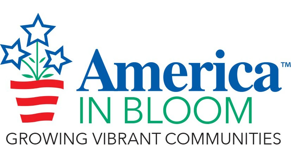 A logo reads America in Bloom TM Growing Vibrant Communities. America TM is in blue lowercase text, in bloom is in uppercase green text and growing vibrant communities is in uppercase black text. To the left of the words is a graphic of a flowerpot with flowers. The pot is red and white striped, the flowers are blue stars and the stems and leaves are green.