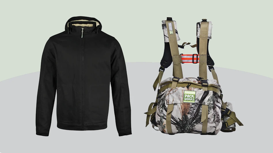 A black winter coat sitting next to a camo-patterned lumbar bag with straps attached as if they were sitting around someone's shoulders.