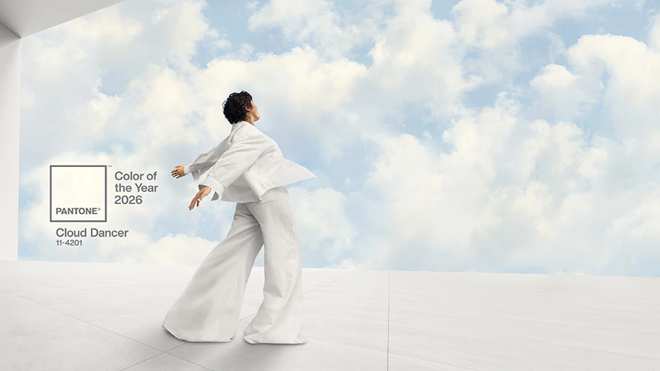 Image for the Pantone Color of the year 2026. A man wearing a flowing robe in the color has his arms outstretched in front of a cloudy sky.