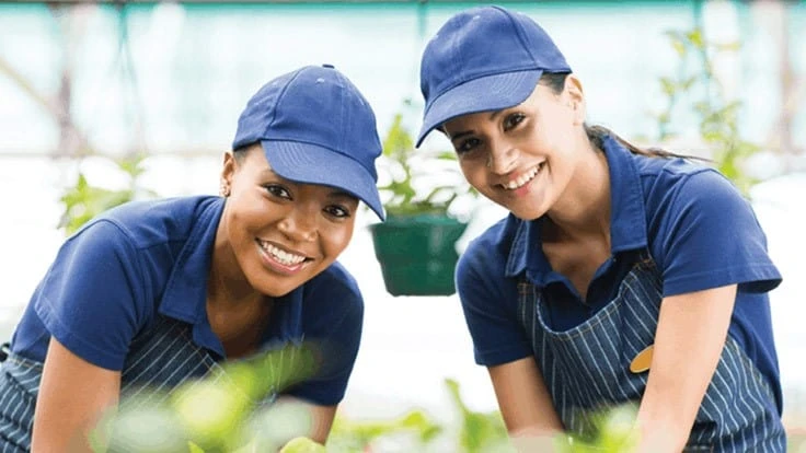 Two women planting plants